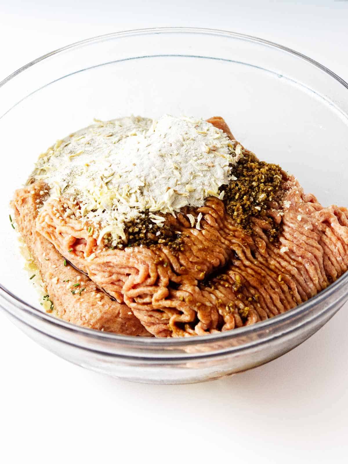 bowl of ground turkey, bread crumbs, and seasonings in a bowl.