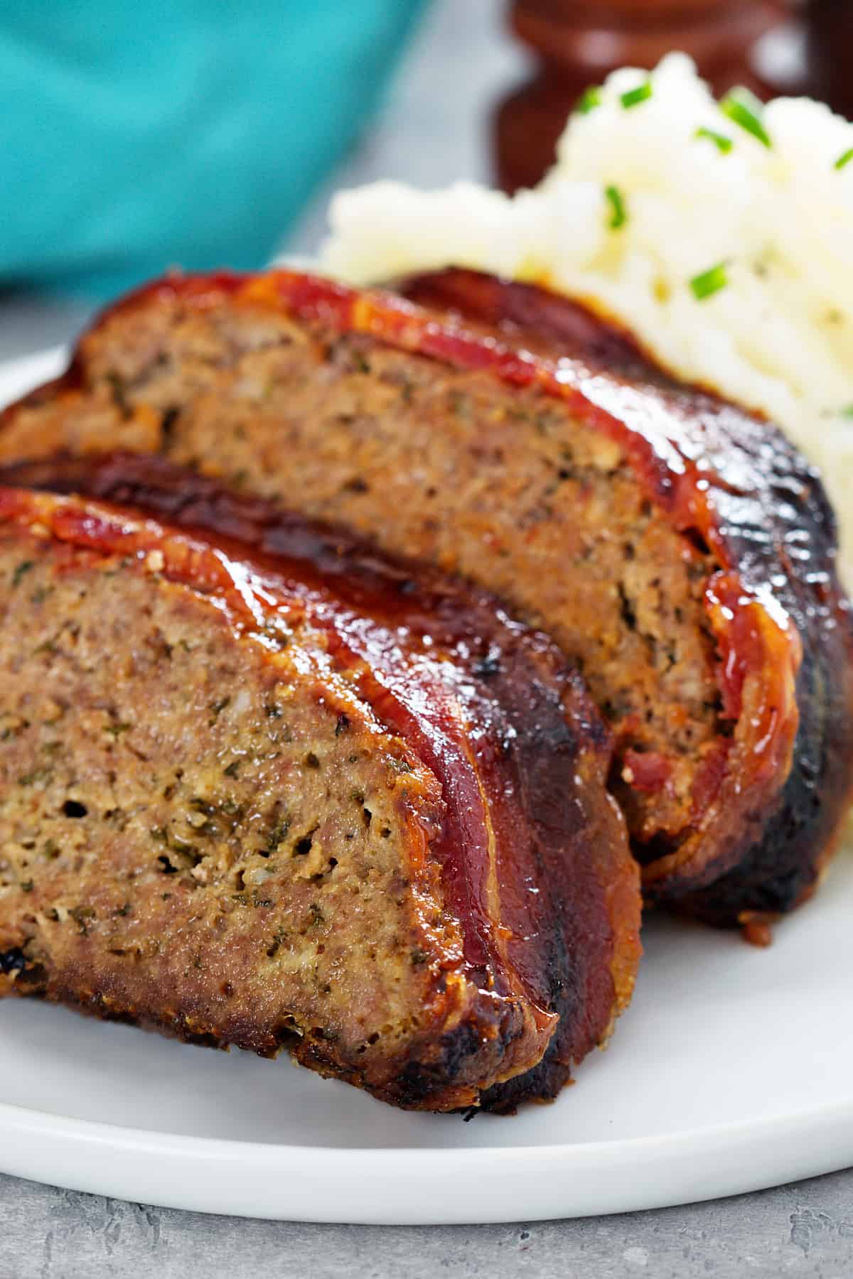 air fryer turkey meatloaf wrapped in bacon with mashed potatoes.