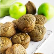 apple flaxseed muffins with Granny Smith apples on a white background.