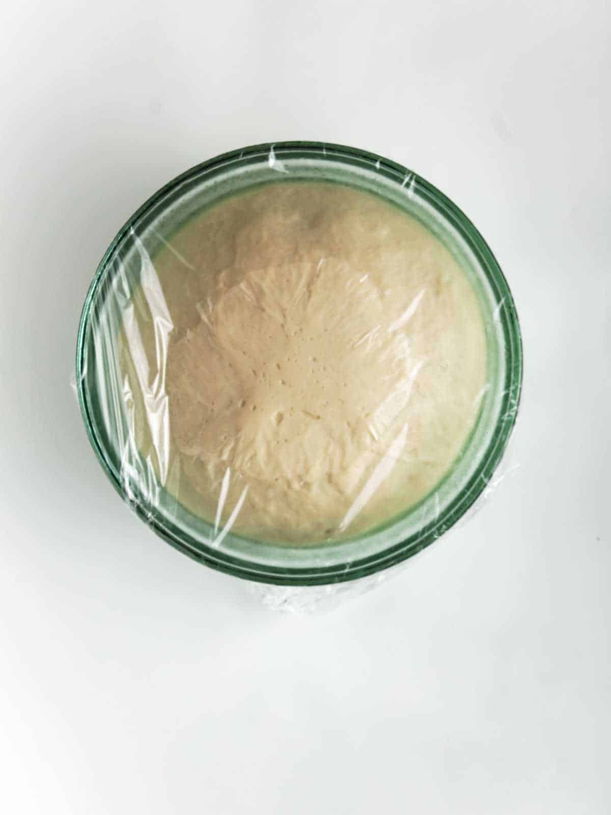 covered bowl of rising yeast dough.