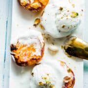 Roasted peaches, with brown sugar ,pistacchio and cinnamon, topped with vanilla ice cream.