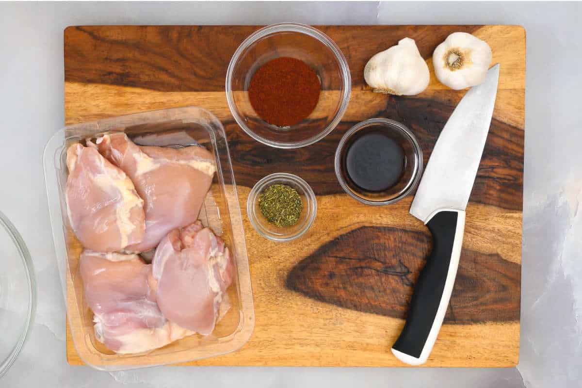 ingredients on a cutting board for poultry with sauce.