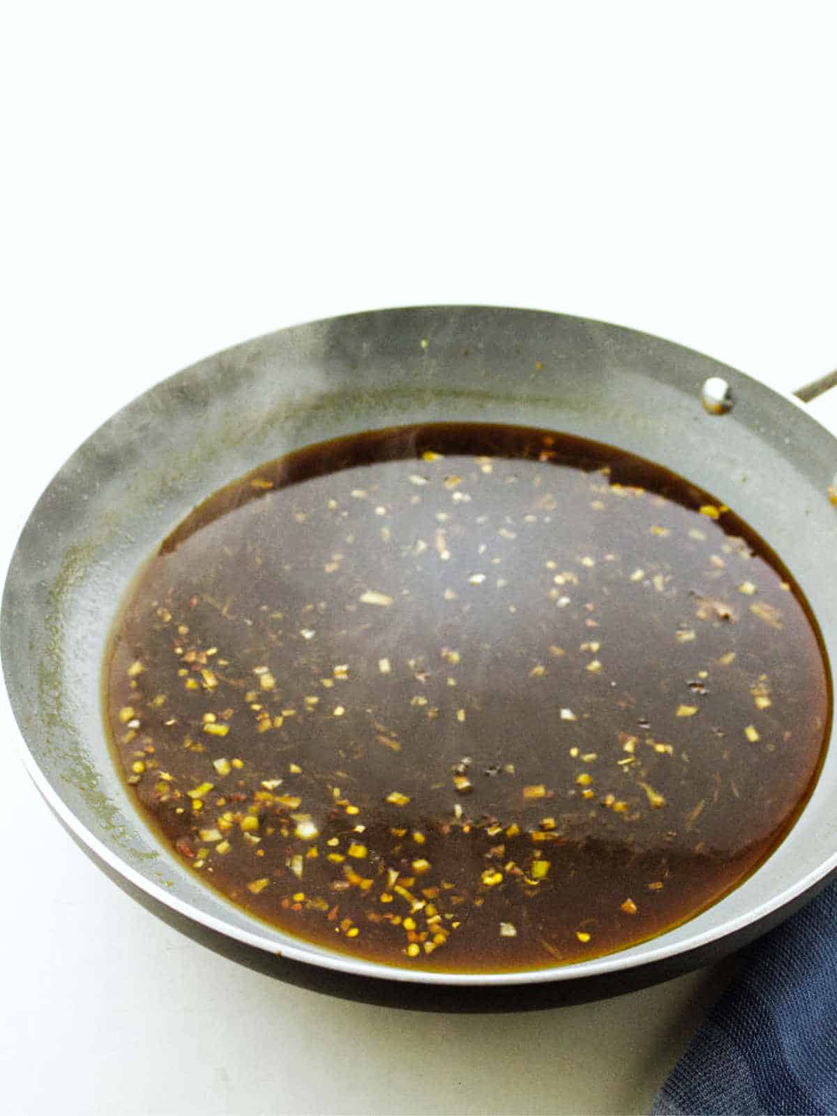 large skillet simmering sauce.