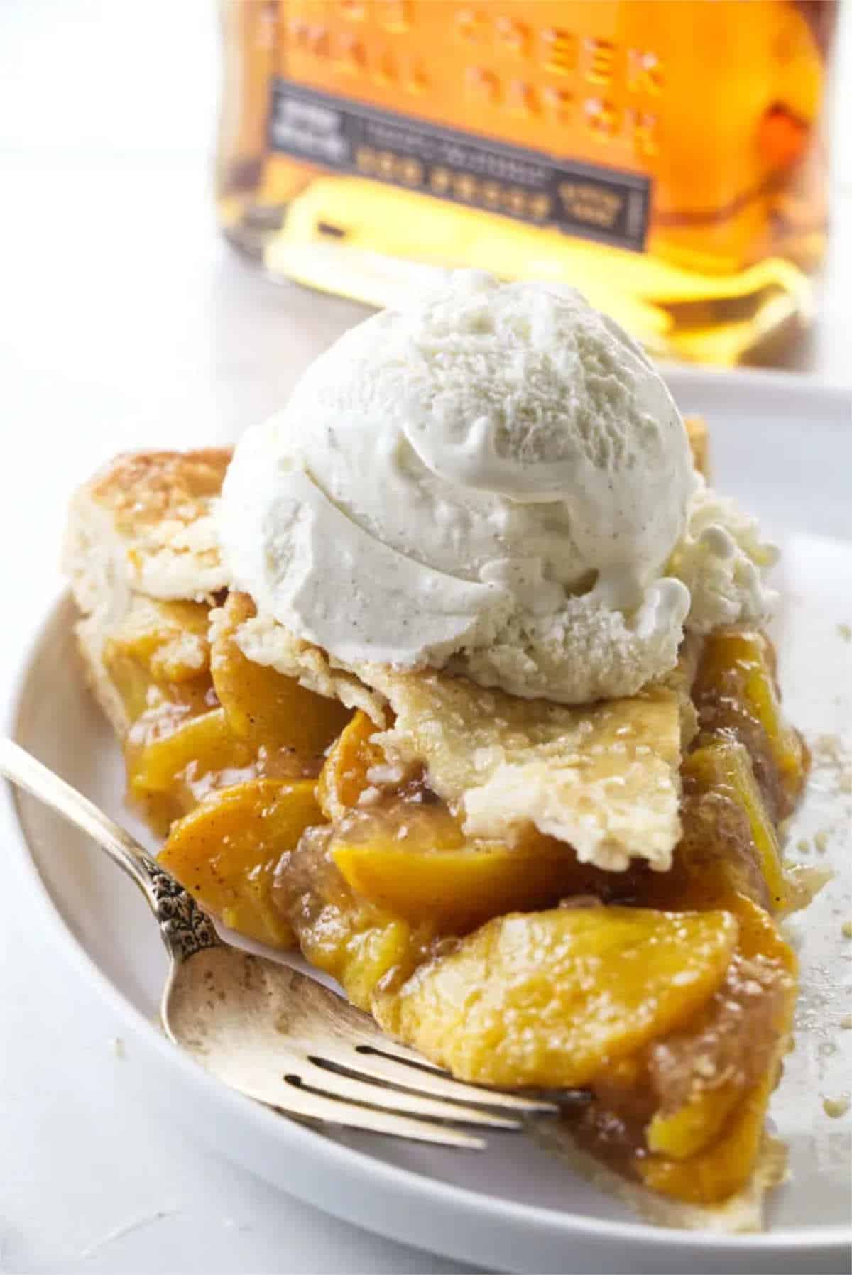 peach pie with ice cream on top.