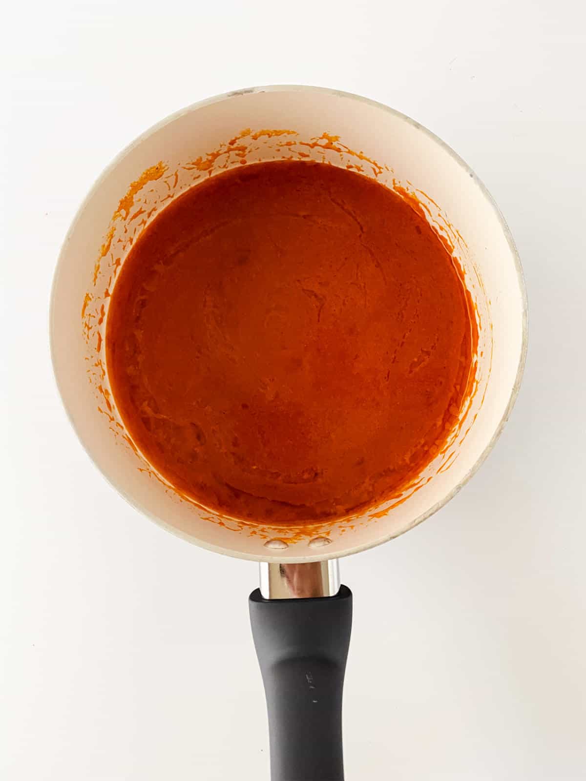 sauce pan with sauce ingredients simmering.