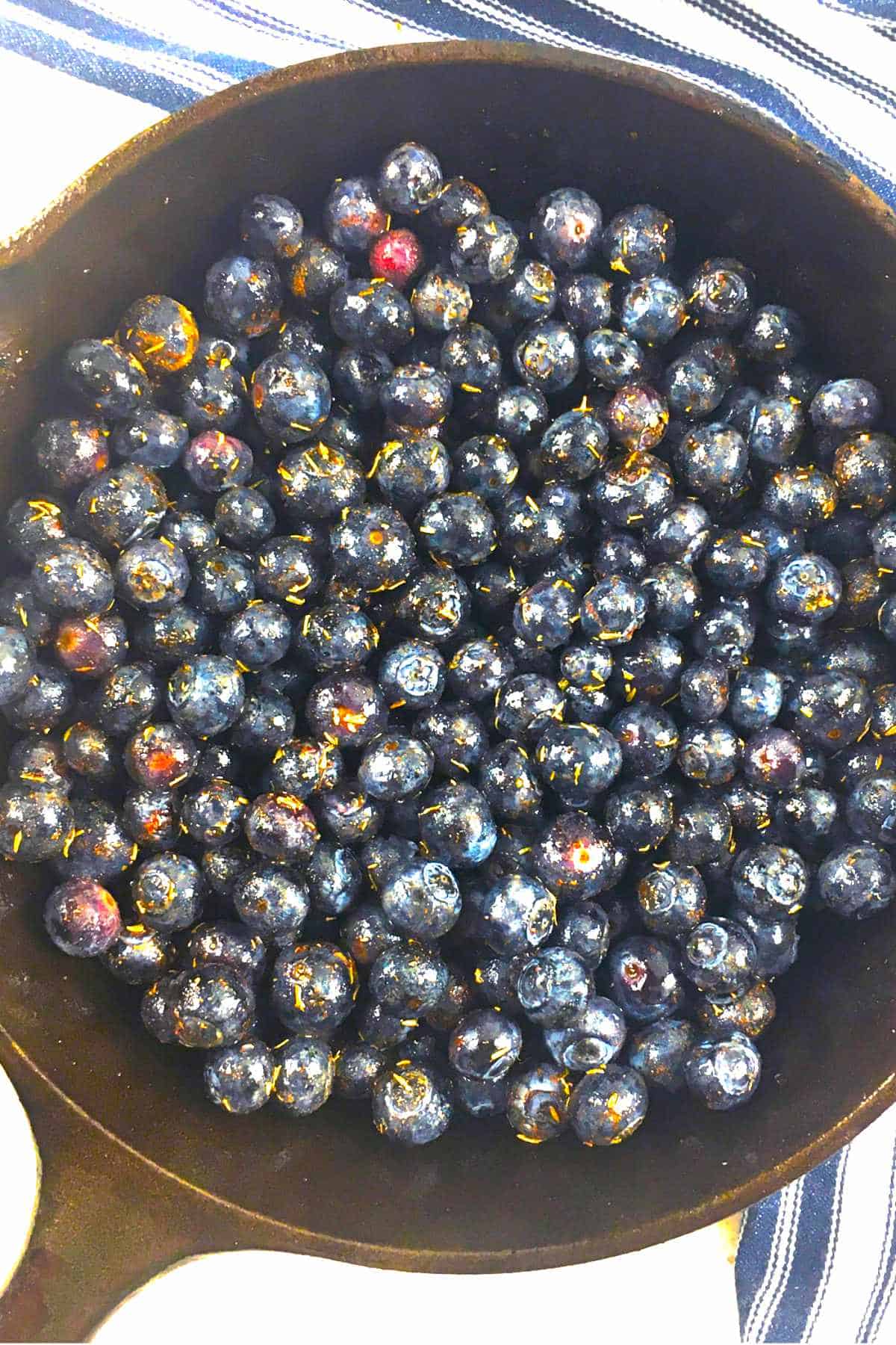ingredients for blueberry crisp added to a cast iron skillet.