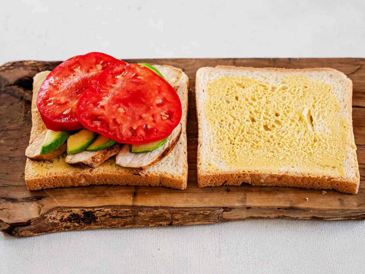 tomato slices on top of sandwich bread slice.