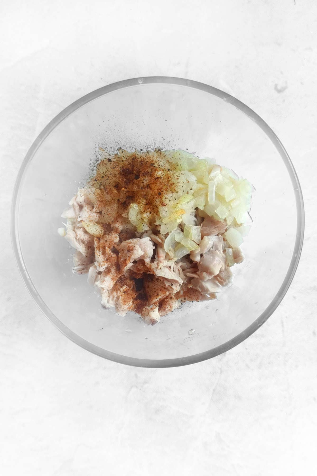 minced meat, onion, and seasonings in a bowl.