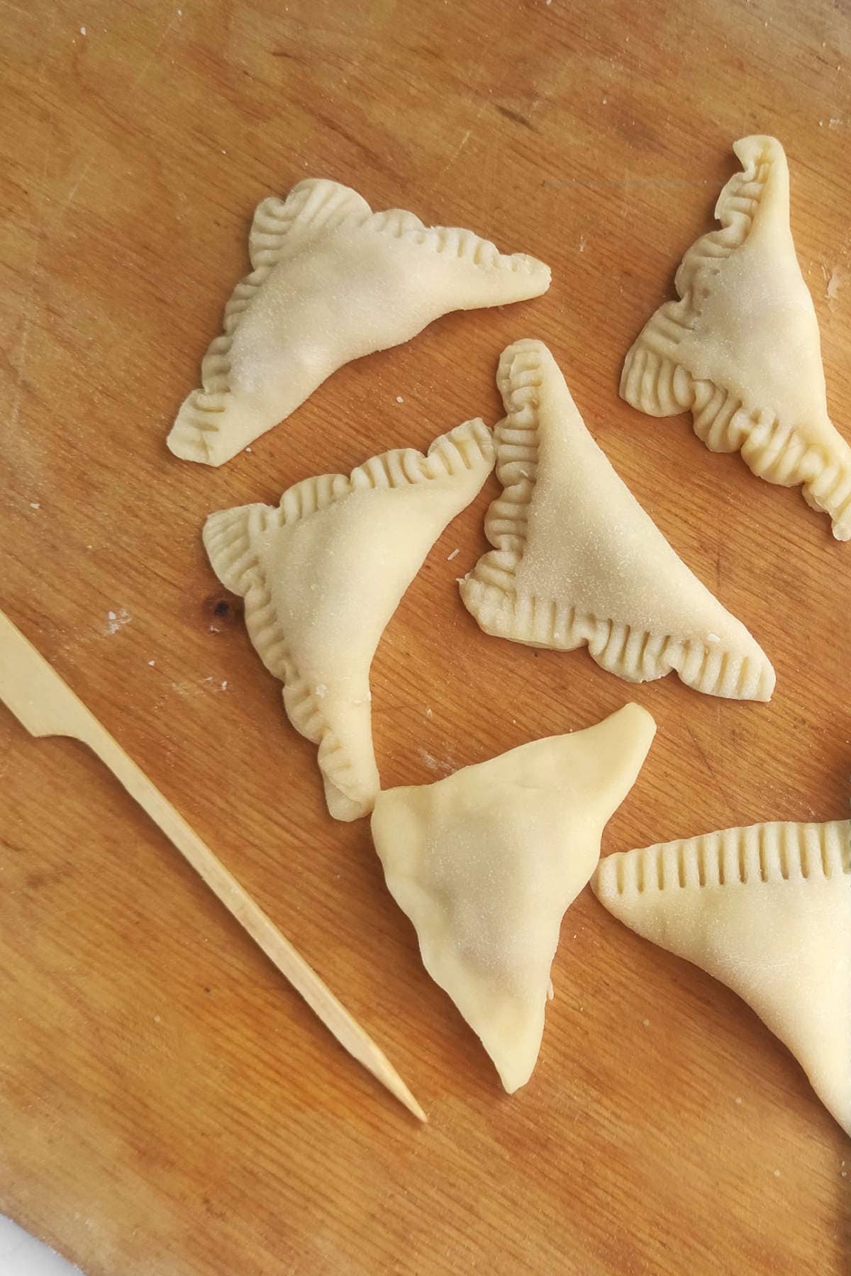 folded triangle dough pockets with crimped edges.