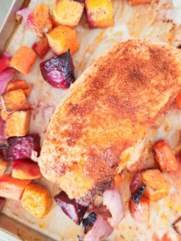 roasted chicken, beets, carrots, sweet potatoes, and onions on a sheet pan.