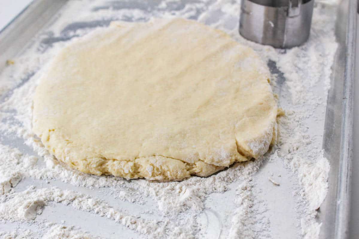 flattened dough on a work surface.