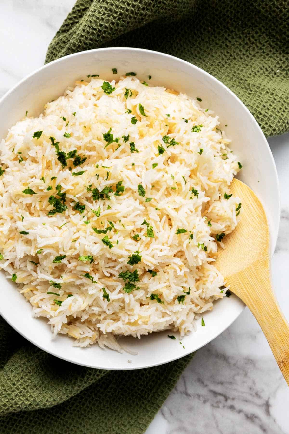bowl of parsley garnished rice pilaf with vermicelli.