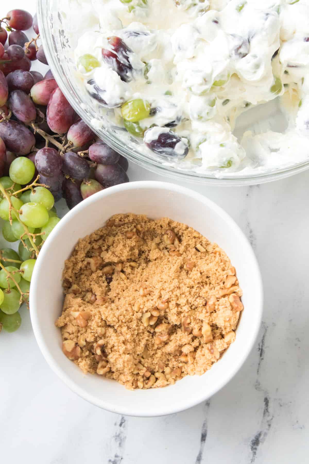 serving dishes with cream cheese grape salad.