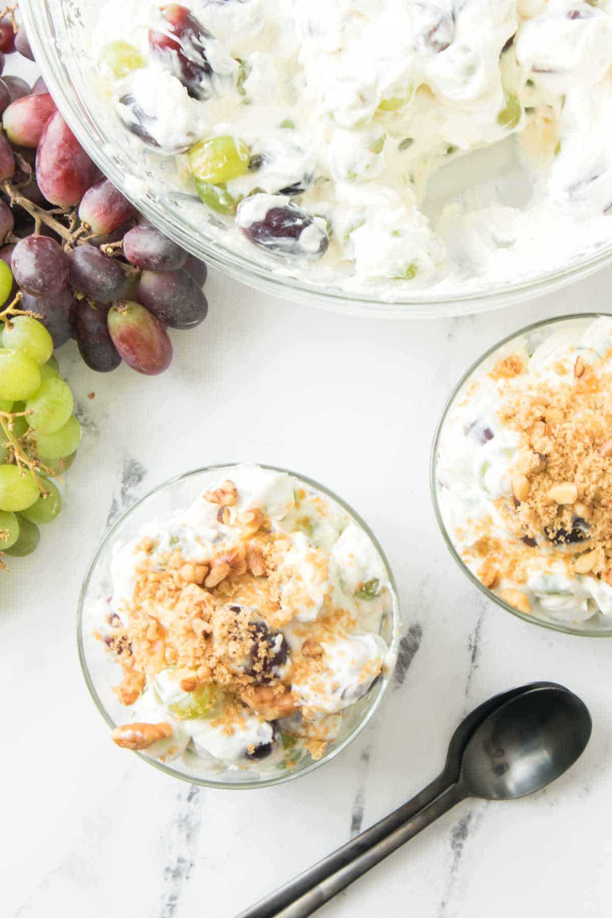 serving dishes with cream cheese grape salad.