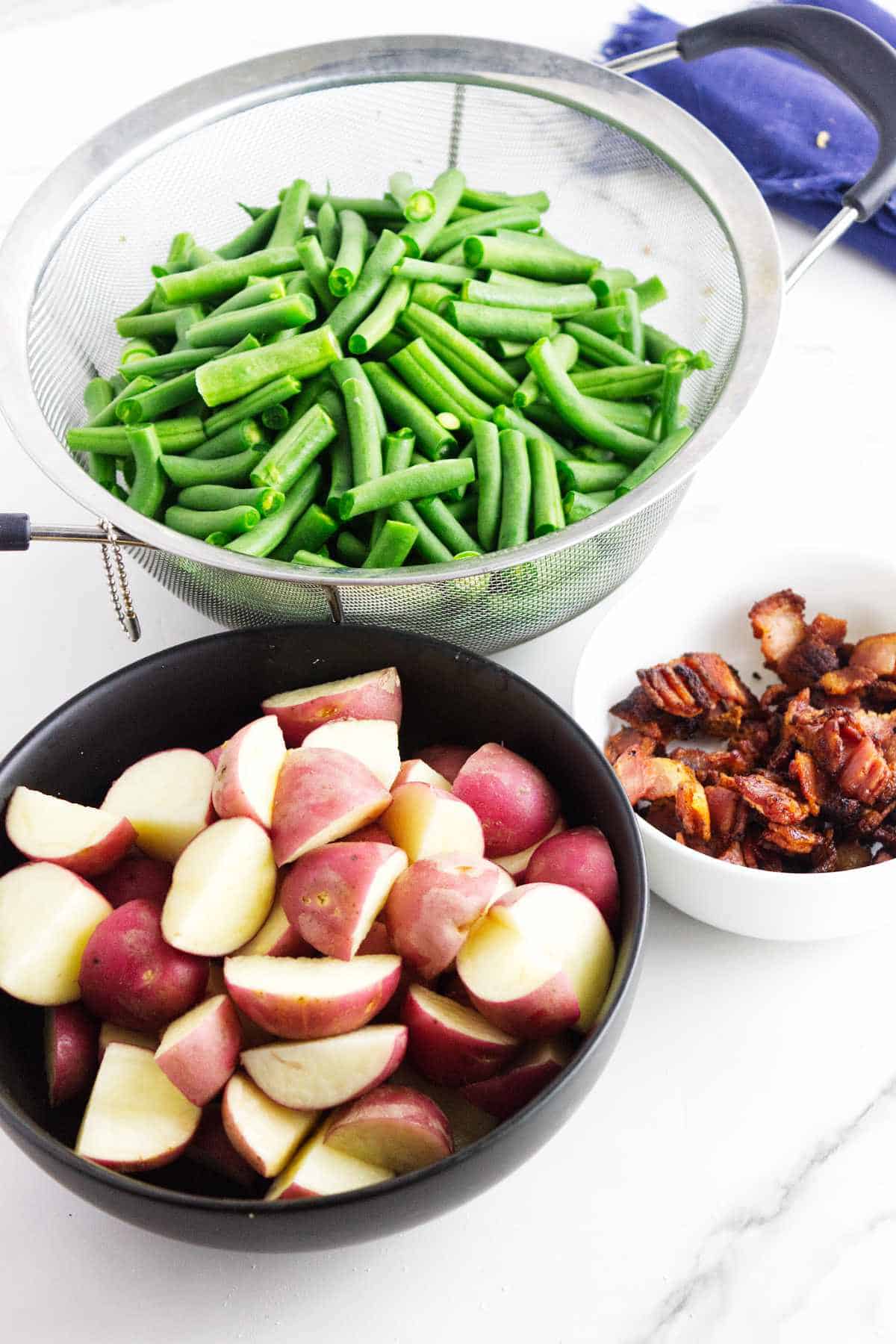 washed and cut green beans, cooked bacon, and quartered red new potatoes.