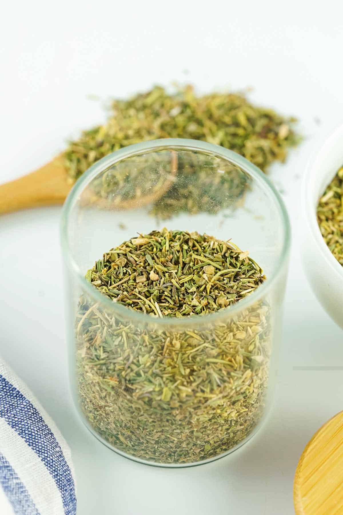 herb mixture stored in a clear glass storage jar.