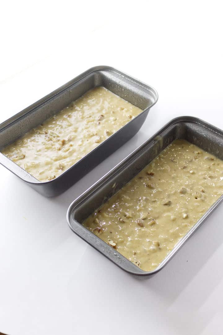 two non stick 4.5 x 8" loaf pans with quick bread batter.