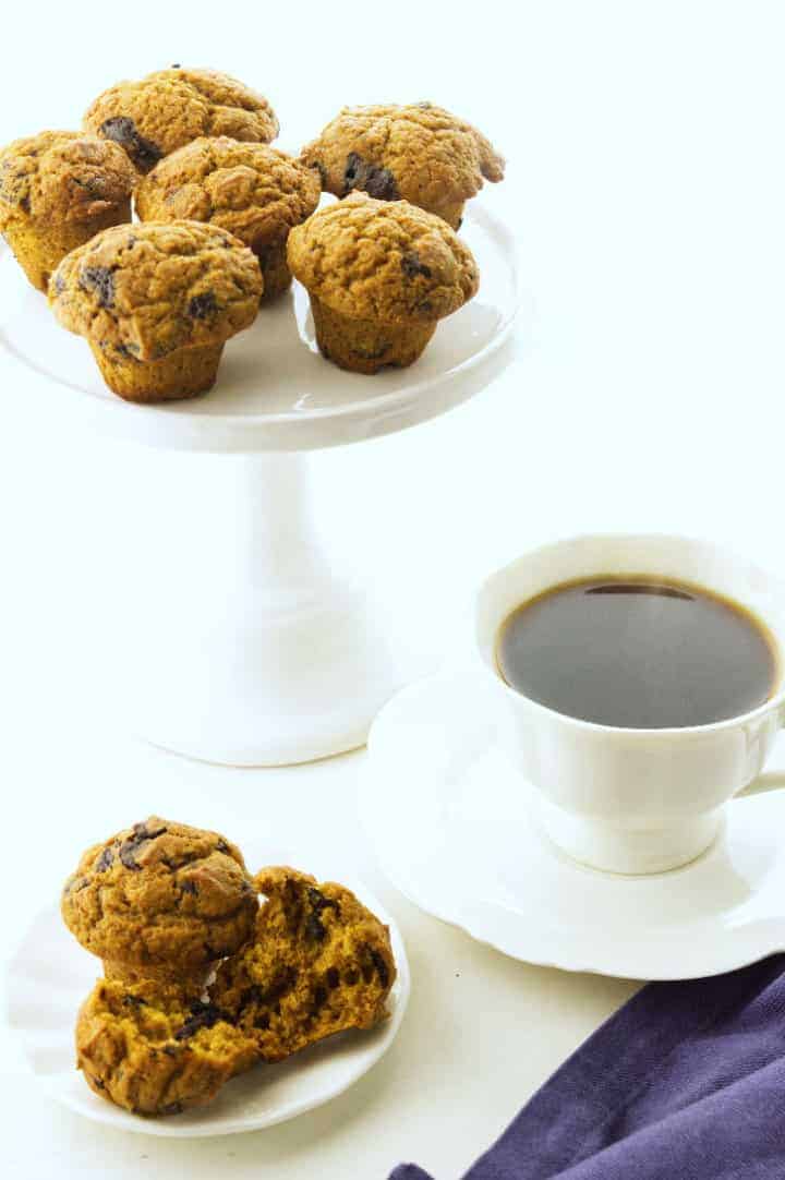 cake stand display of mini pumpkin muffins with cup of coffee.