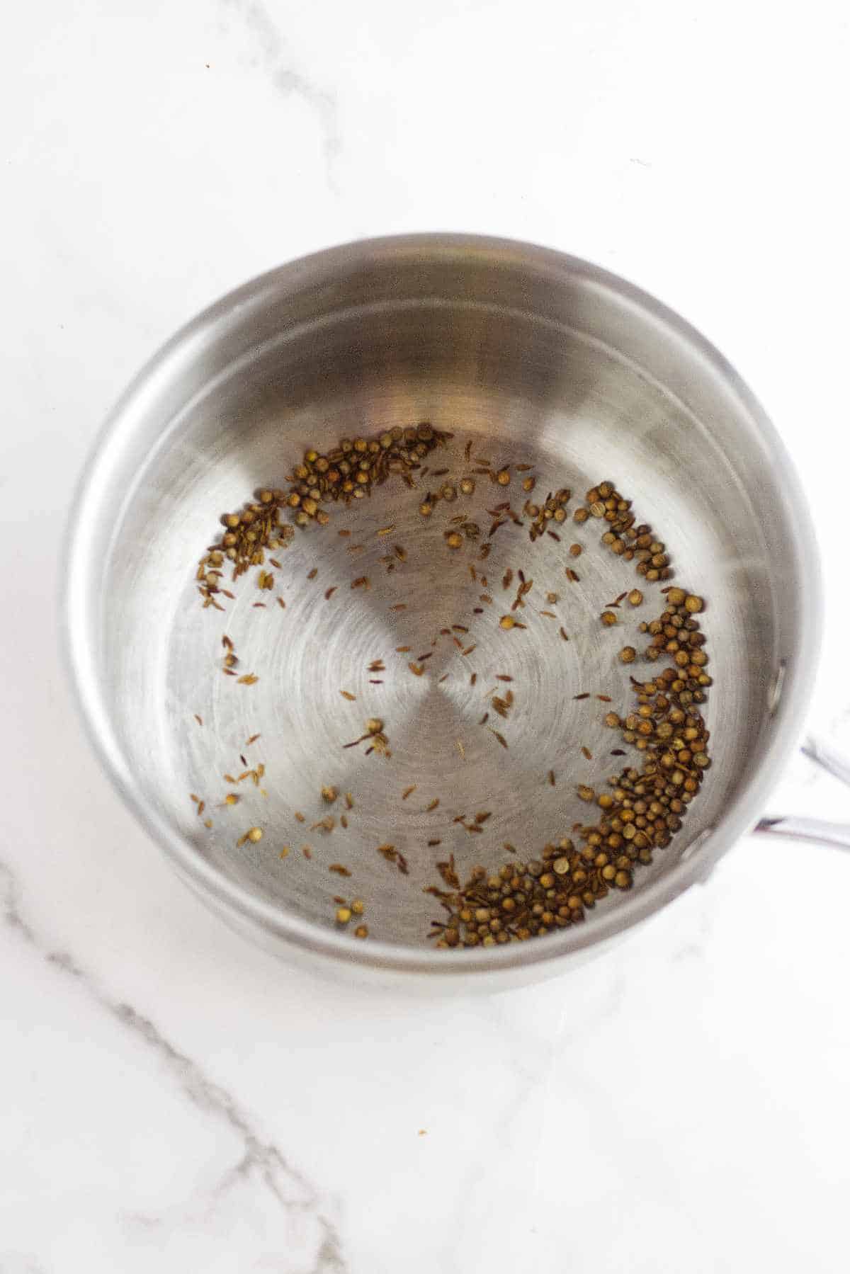 dry frying spices in a sauce pan.