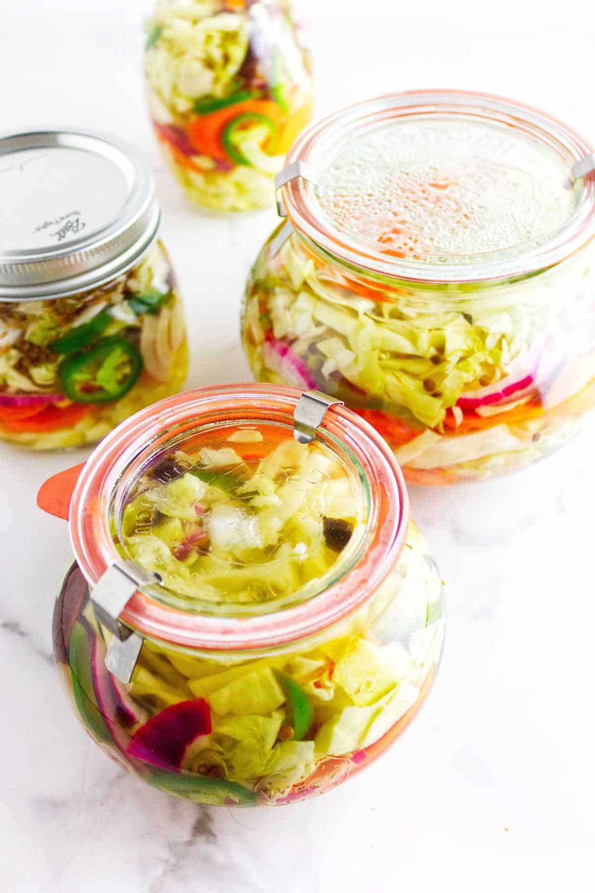 Sealed Weck Jars with gaskets and clips on jars of Mexican pickled vegetables.