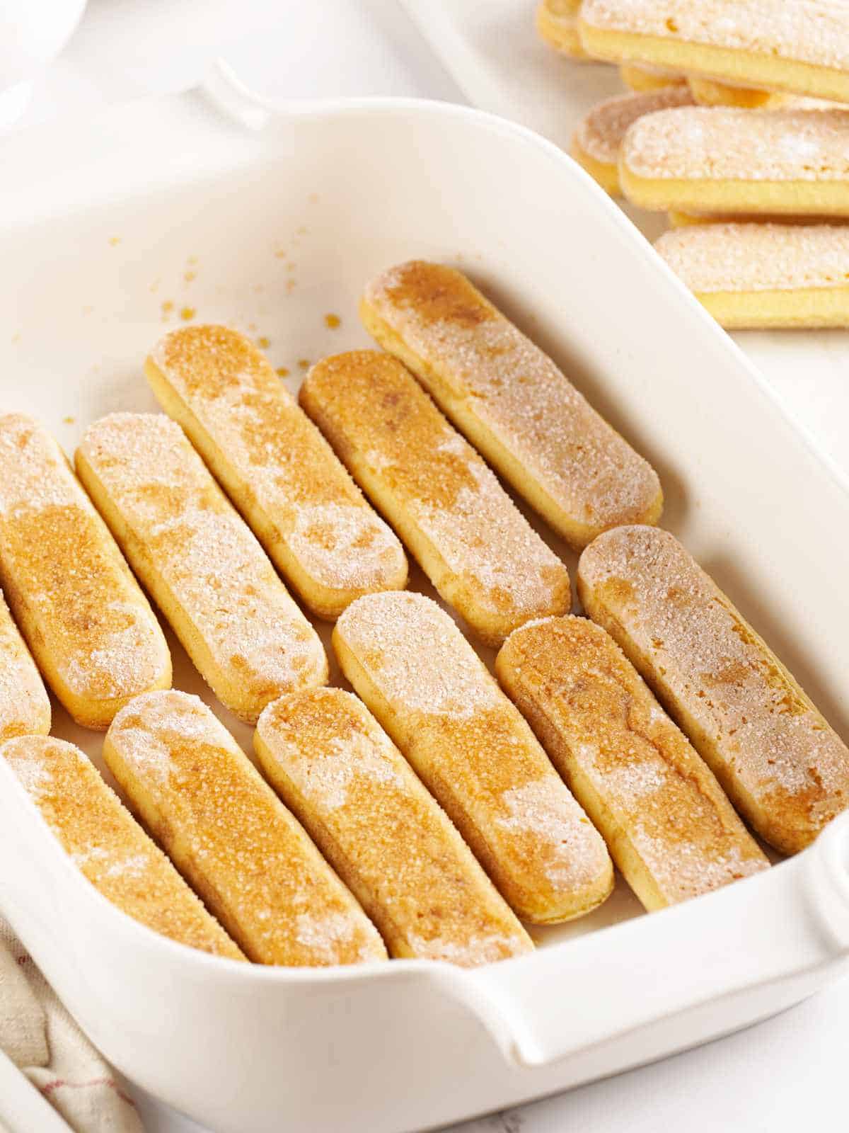 ladyfinger cookies as bottom layer in a casserole dish, drizzled with espresso.