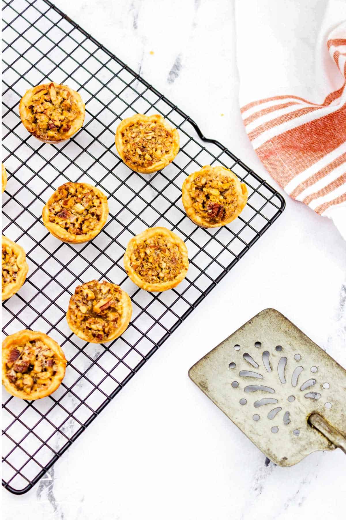 cooling pecan tassies on a cooling rack.