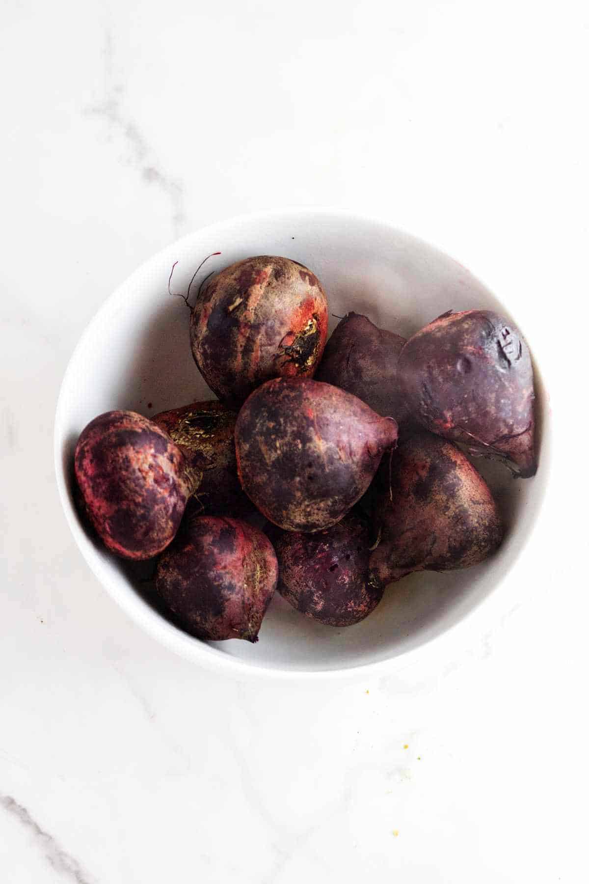roasted whole beets in a bowl.