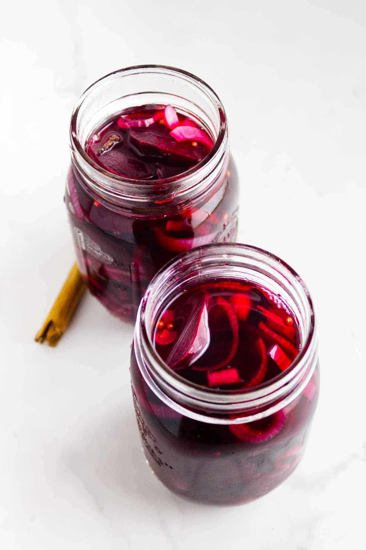 hot brine added to cover beetroot slices in mason jars.