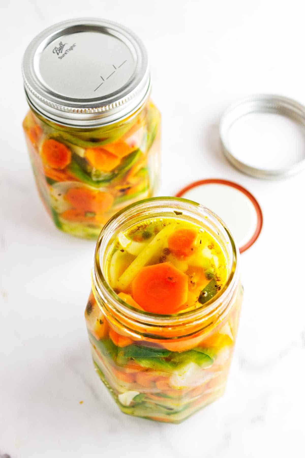 hot packed mason jars with quick pickled carrots.