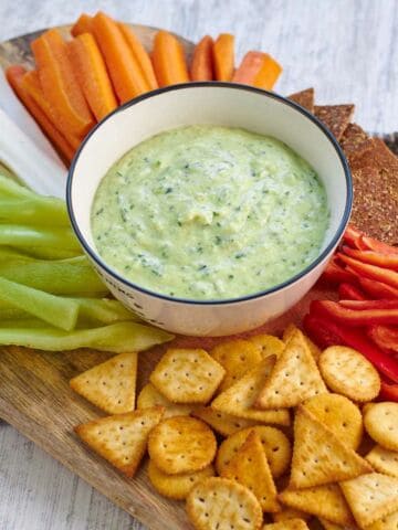 zucchini dip with carrot sticks and crackers.