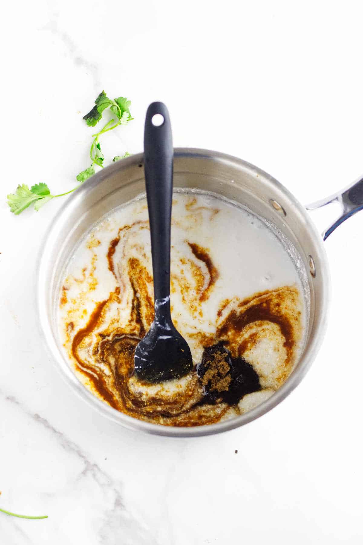 sauce pan with coconut milk and peanut sauce ingredients.