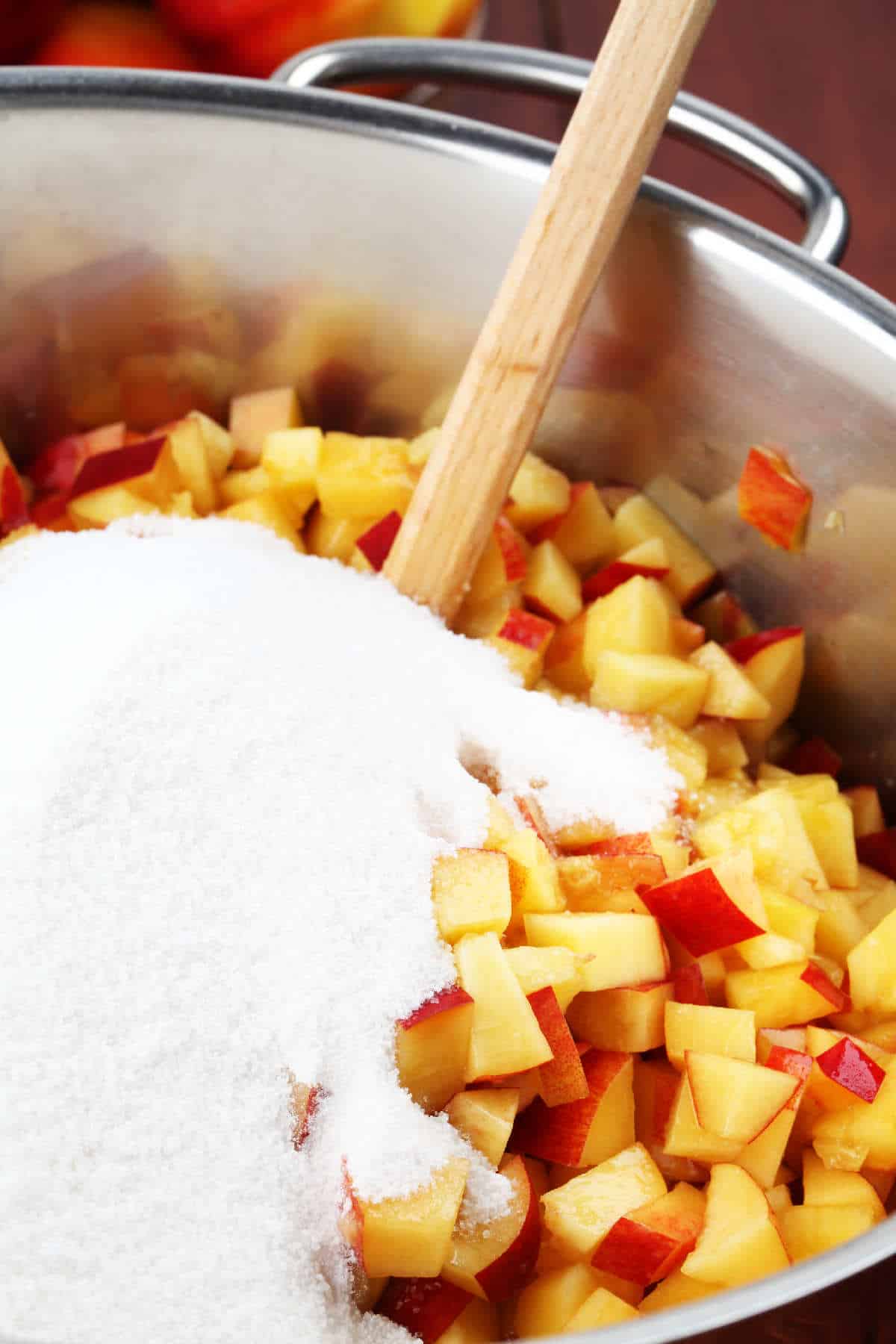 sugar added to pot of diced peaches.