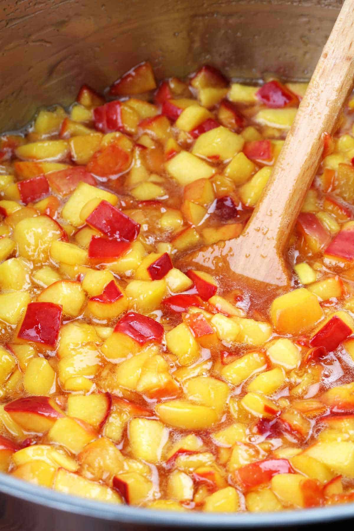 simmering pot of diced peaches.