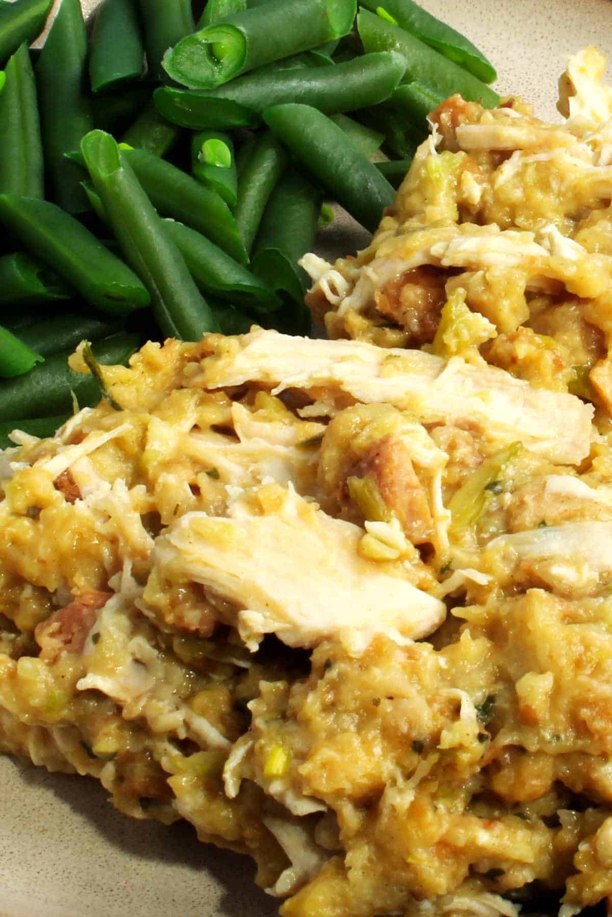 4 ingredient slow cooker chicken with stuffing on a plate with green beans.