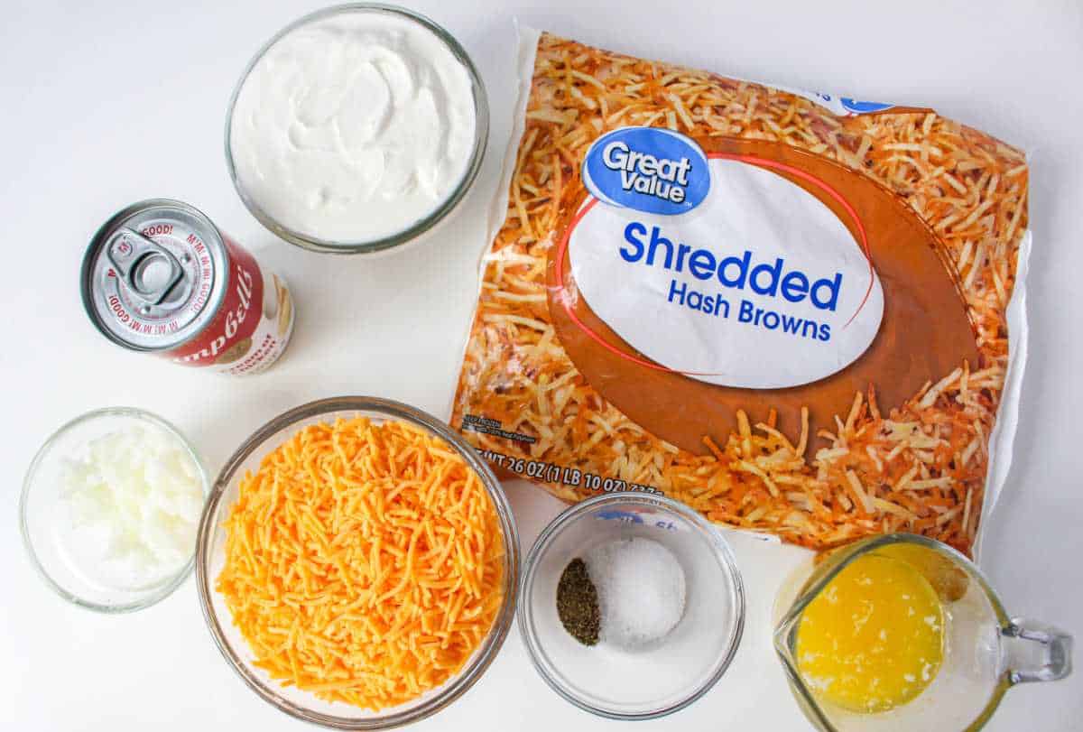 frozen hash browns, shredded cheese, soup, and sour cream on a white background.
