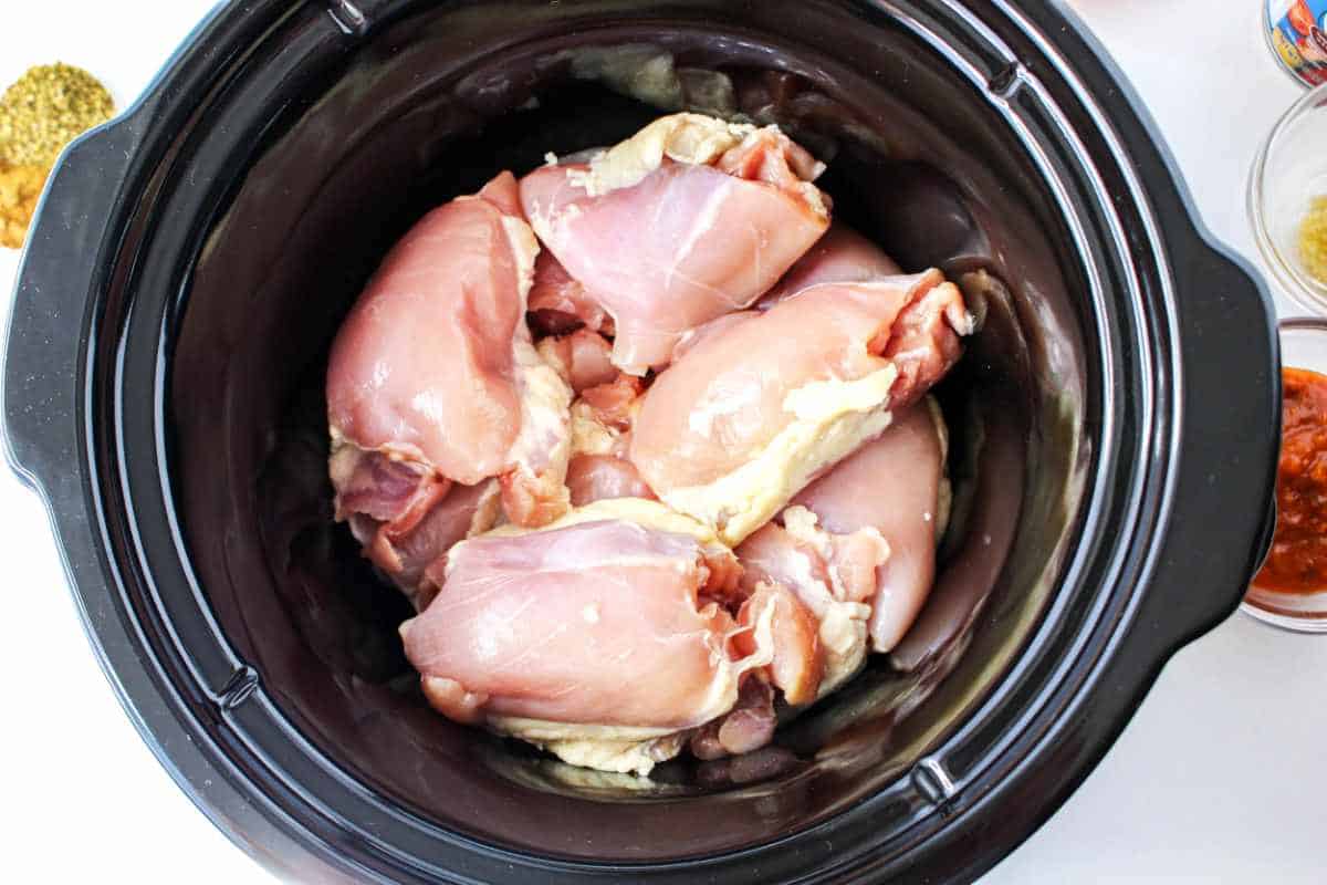 raw chicken thighs in a crockpot.