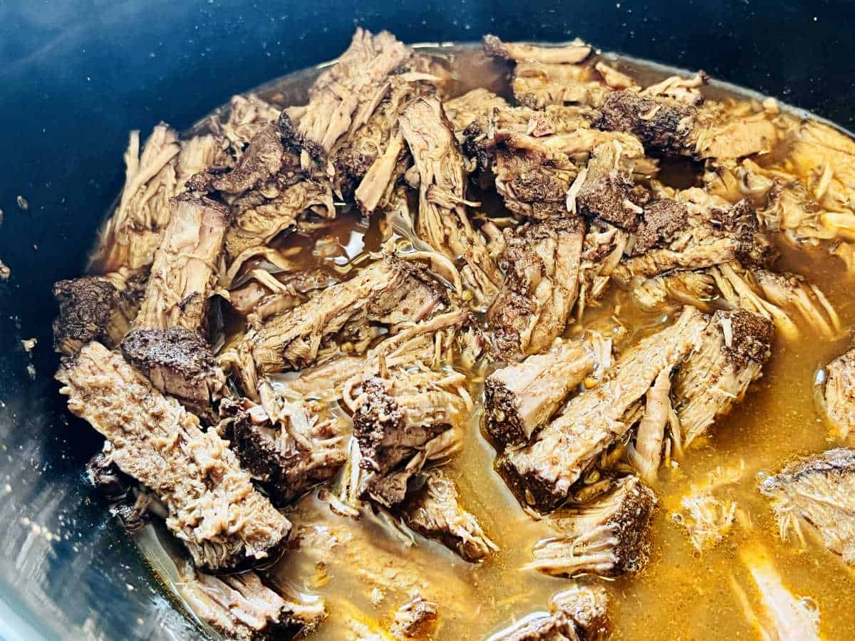 slow cooker shredded meat in broth.