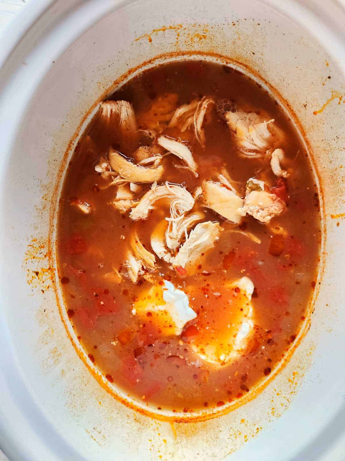 shredded chicken in sauce in a crockpot.