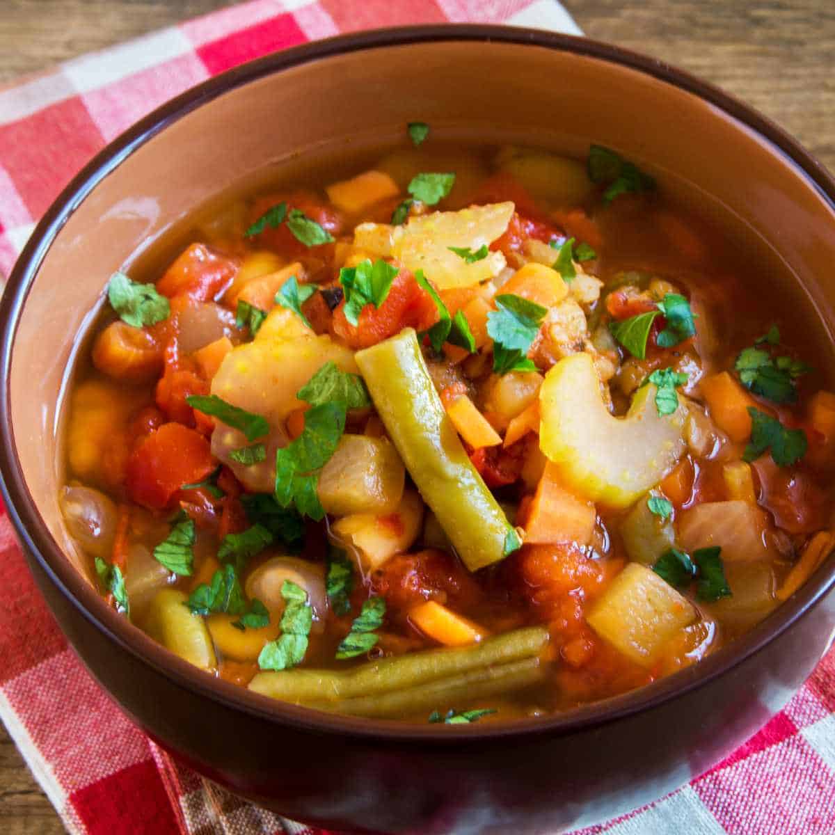 slow cooker vegetable soup in a serving bowl.