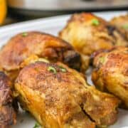 slow cooked caribbean chicken thighs on a platter.