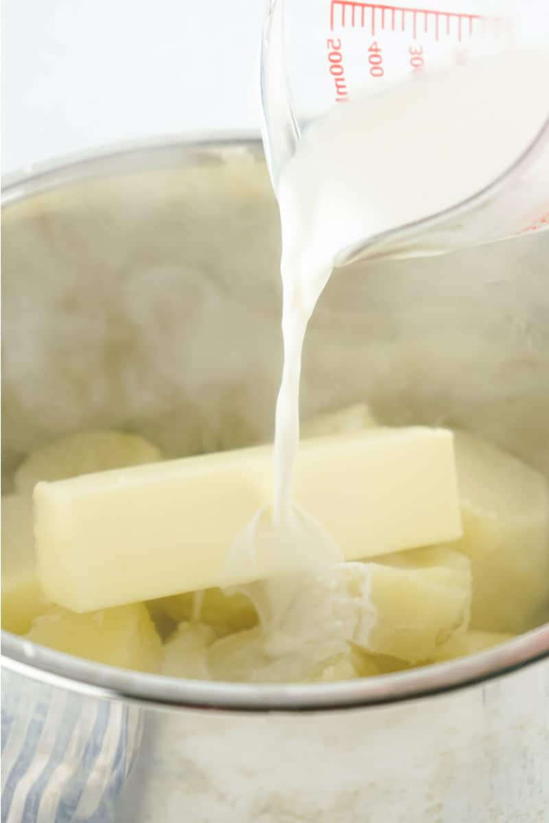 milk and butter added to cooked potatoes in an instant pot.