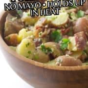 Red white and bleu potato salad in a wooden bowl with blue cheese and herbs.