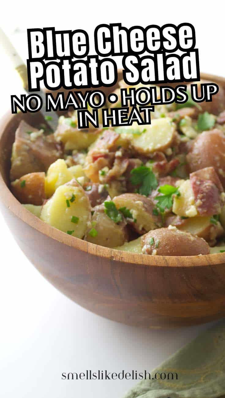 Red white and bleu potato salad in a wooden bowl with blue cheese and herbs.
