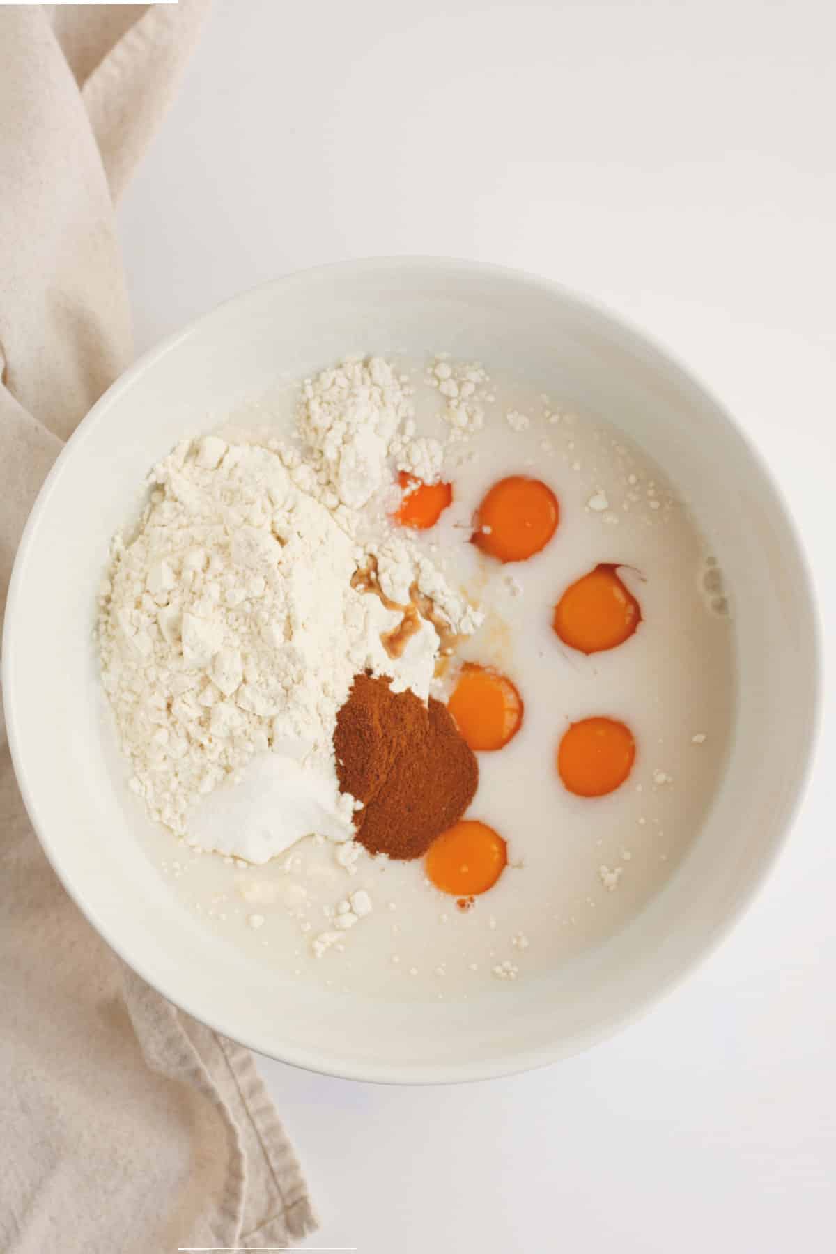 white ceramic bowl with unmixed pancake ingredients
