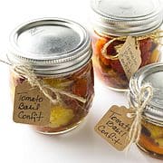 three ball canning jars filled with tomato confit with hang tags