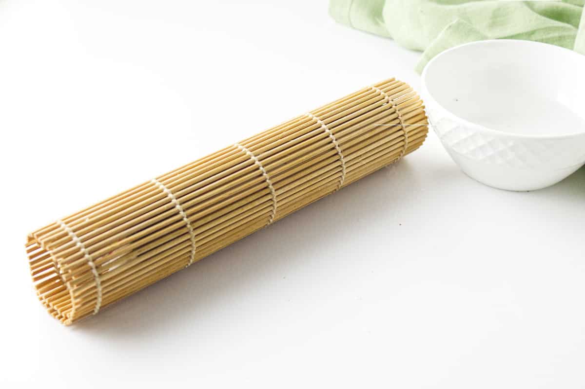 bamboo rolling mat with korean sushi roll inside.