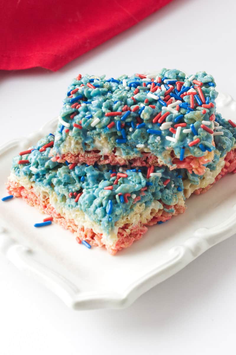 Three 4th of July Rice Crispy treats on a small white plate.