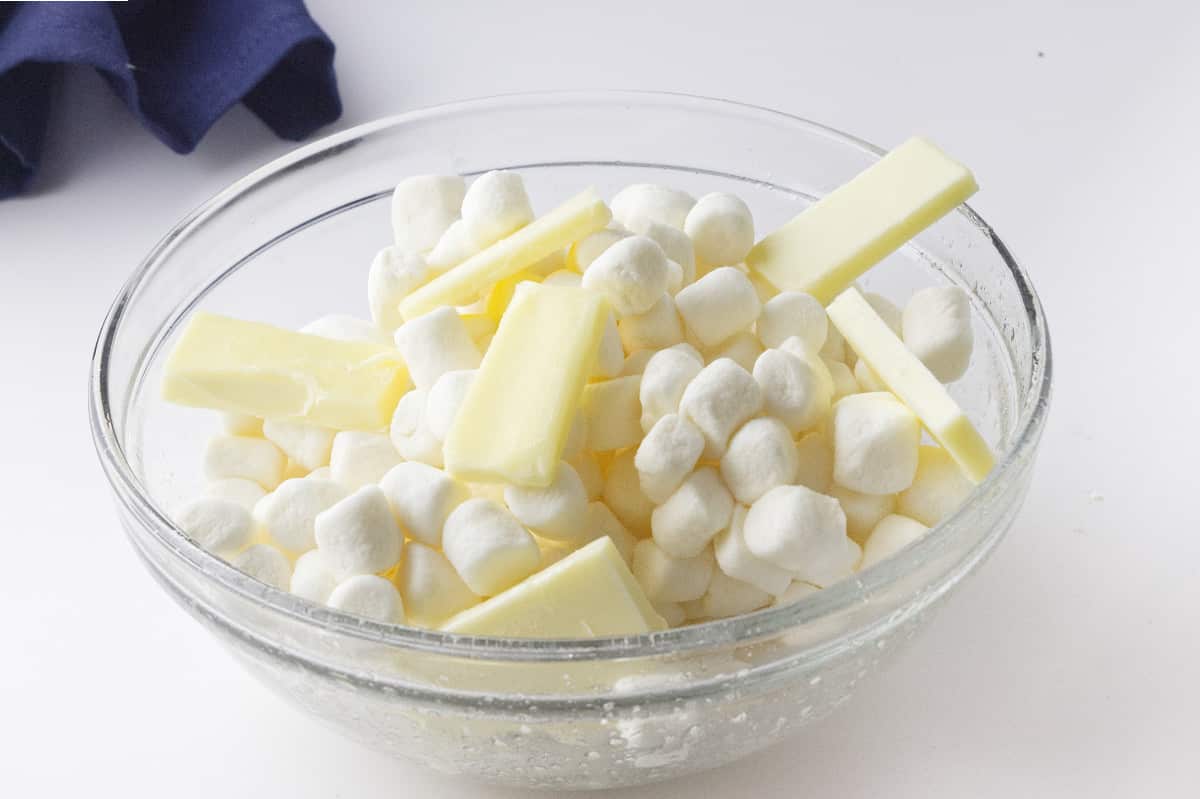 clear glass bowl of mini marshmallows and cubed butter