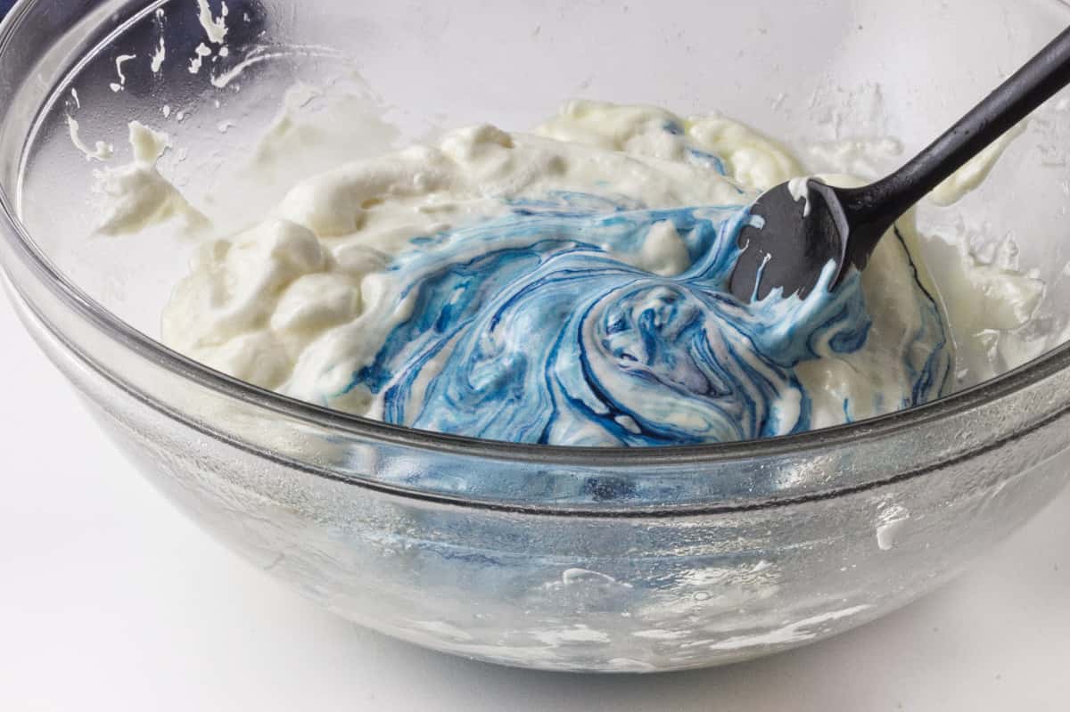 blue colored marshmallow mixture in a clear glass bowl