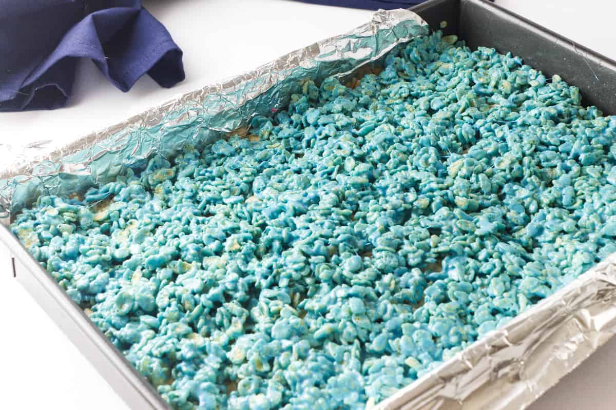 pan of rice crispy treats with blue colored layer on top.